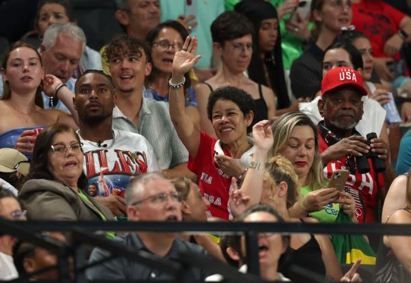 Simone Biles' husband Jo<em></em>nathan Owens (l.), and her parents Nellie (c.) and Ro<em></em>nald (r.) watch Biles compete in the vault during the women's team final at the Olympics on July 30, 2024.