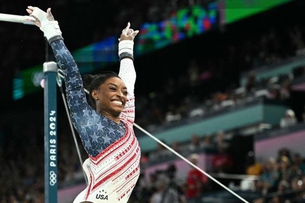 Simone Biles reacts after competing in the uneven bars during the team gymnastics final on July 30, 2024.