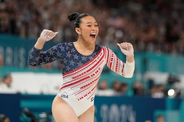 Suni Lee celebrates after her balance beam performance during the team final at the Olympics on July 30, 2024.