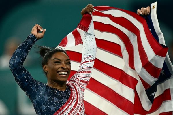 US' Simone Biles celebrates after team USA won the artistic gymnastics women's team final during the Paris 2024 Olympic Games