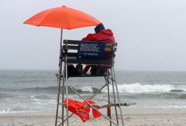 NYC Lifeguards standing watch at an empty beach 35 in the Rockaways in Queens,