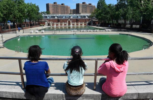 Three girls look at the pool at the Hamilton Fish Park on Pitt St. on the Lower East Side