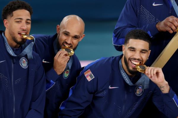 From left: Tyreese Haliburton of the Pacers and Celtics teammates Derrick White and Jayson Tatum pose with their gold medals after Team USA's win over France at the 2024 Olympics on Aug. 10, 2024.