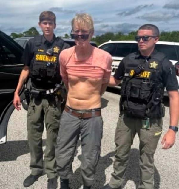 In this imaged released by the Martin County, Fla., Sheriff's Office, law enforcement officers arrest Ryan Routh, the man suspected in the apparent assassination attempt of Do<em></em>nald Trump, Sunday, Sept. 15, 2024. (Martin County Sheriff's Office via AP)