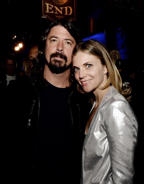 Dave Grohl (L) and his wife Jordyn Blum pose at an after-party in 2013.